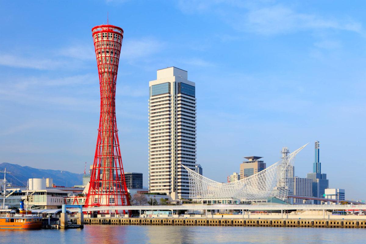 The Kōbe Port Tower stands out against the backdrop of the main harbor with its 108 meters and distinctive exterior, Osaka, Japan - © leungchopan - stock.adobe.com
